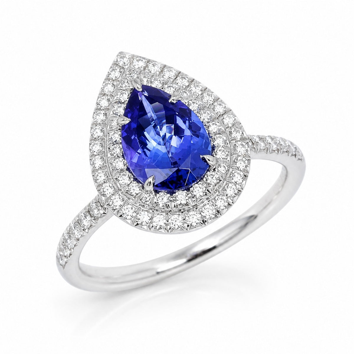 A pear-cut blue tanzanite ring set in a double halo, set with diamonds. soleste style