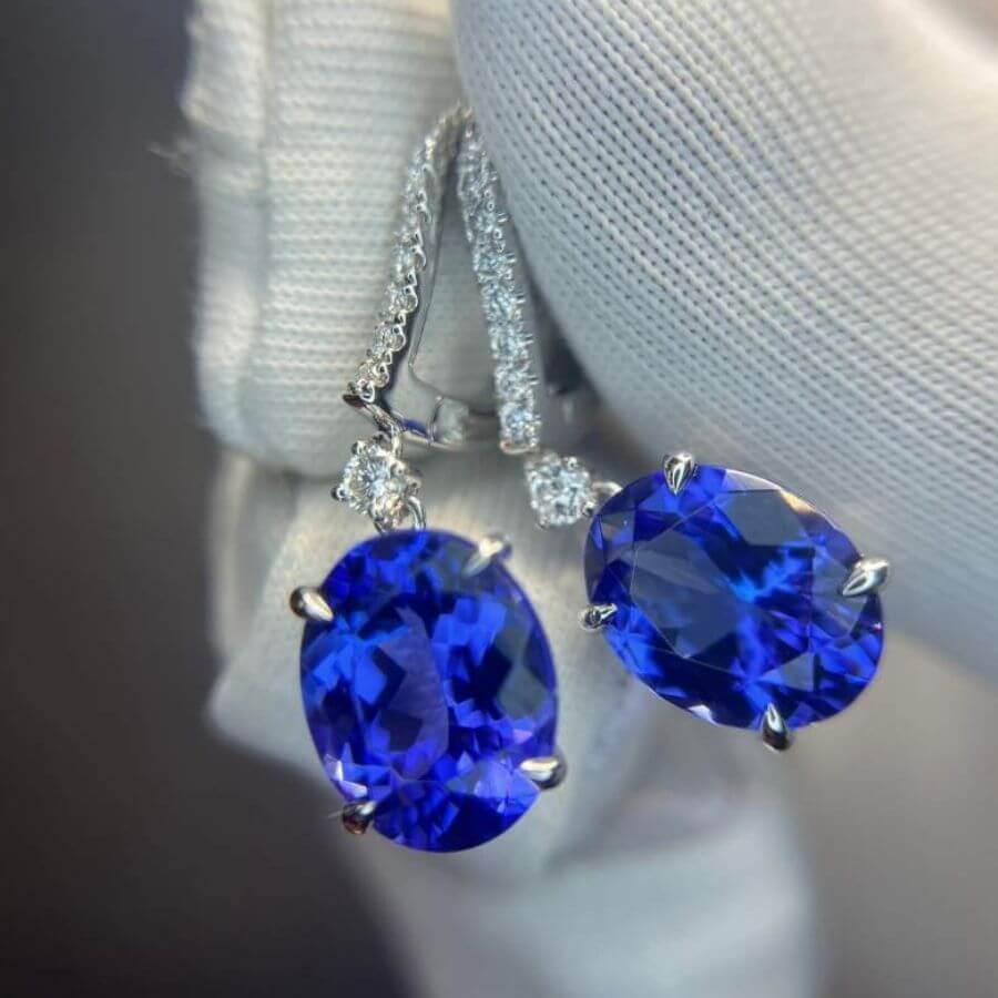 Natural tanzanite earrings with oval cut gemstones, 7.00 carats total, white gold setting.